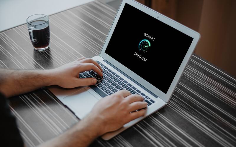opened laptop looking at internet speed test