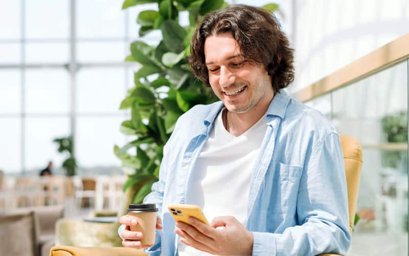 man looking at phone and smiling